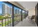 This inviting balcony features seating and a scenic view of the surrounding buildings and coastal landscape at 1581 Gulf Blvd # 403N, Clearwater Beach, FL 33767