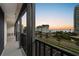 Relaxing balcony view showcasing beachfront condos, a beautiful beach, and a scenic sunset in the distance at 1581 Gulf Blvd # 403N, Clearwater Beach, FL 33767