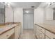 Spacious bathroom with dual vanities, marble countertops, and ample storage featuring a connected closet at 1581 Gulf Blvd # 403N, Clearwater Beach, FL 33767
