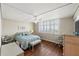 Bright and airy bedroom with hardwood floors, a ceiling fan, and a beautiful view from the large picture windows at 1581 Gulf Blvd # 403N, Clearwater Beach, FL 33767
