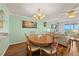 Charming dining area with hardwood floors, chandelier lighting, and access to living room at 1581 Gulf Blvd # 403N, Clearwater Beach, FL 33767