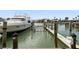 View of a private boat dock with a yacht, offering waterfront access and boating opportunities at 1581 Gulf Blvd # 403N, Clearwater Beach, FL 33767