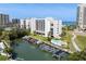 Beautiful exterior view of waterfront condos featuring a pool and private boat slips at 1581 Gulf Blvd # 403N, Clearwater Beach, FL 33767