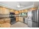 Modern kitchen featuring stainless steel appliances, granite counters, and tile flooring at 1581 Gulf Blvd # 403N, Clearwater Beach, FL 33767