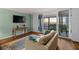 Cozy living room with water views, stylish rug, and sliding glass doors to balcony at 1581 Gulf Blvd # 403N, Clearwater Beach, FL 33767