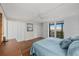 Comfortable main bedroom features hardwood floors, generous closet space, and beautiful views from the sliding glass doors at 1581 Gulf Blvd # 403N, Clearwater Beach, FL 33767