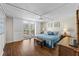 Spacious main bedroom features hardwood floors, a ceiling fan, and sliding glass doors leading to a balcony at 1581 Gulf Blvd # 403N, Clearwater Beach, FL 33767