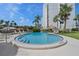 Inviting pool area featuring a tiki hut, lounge chairs, and well-maintained landscaping surrounding the pool at 1581 Gulf Blvd # 403N, Clearwater Beach, FL 33767