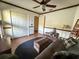 Bedroom with a ceiling fan, hardwood floors, and a storage chest at 1716 Bondurant Way, Brandon, FL 33511