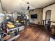 Living room with hardwood floors, a ceiling fan, and a stone fireplace at 1716 Bondurant Way, Brandon, FL 33511
