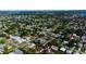 Expansive aerial view of a residential neighborhood with mature trees and numerous single-Gathering homes near a winding body of water at 1835 Michigan Ne Ave, St Petersburg, FL 33703