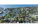 Wide aerial shot of a residential area with canal access, showcasing homes nestled among mature trees near a tranquil bay at 1835 Michigan Ne Ave, St Petersburg, FL 33703