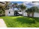 Expansive backyard featuring a shed, chicken coop, lush lawn, and privacy fence at 1835 Michigan Ne Ave, St Petersburg, FL 33703