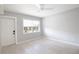 Bright, freshly painted bedroom with white floors, ceiling fan, and window views at 1835 Michigan Ne Ave, St Petersburg, FL 33703
