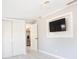 A cozy bedroom showcasing a built-in TV niche and a closet at 1835 Michigan Ne Ave, St Petersburg, FL 33703