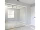 Bedroom featuring mirrored closet doors reflecting the bright interior at 1835 Michigan Ne Ave, St Petersburg, FL 33703