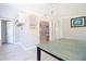 Bright dining area with white-wood look flooring, chandelier, and access to the kitchen at 1835 Michigan Ne Ave, St Petersburg, FL 33703