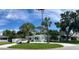 Charming single-story home with an inviting front porch, American flag, and well-manicured lawn at 1835 Michigan Ne Ave, St Petersburg, FL 33703