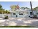 Charming single-story home with an inviting front porch, American flag, and pea gravel driveway at 1835 Michigan Ne Ave, St Petersburg, FL 33703