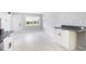 Open living area with white wood-look floors, neutral paint, and lots of natural light at 1835 Michigan Ne Ave, St Petersburg, FL 33703