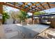 Outdoor dining on the patio featuring a pergola, grill, and landscaped yard at 1835 Michigan Ne Ave, St Petersburg, FL 33703