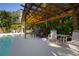 Patio with a pergola, bar seating, and views of the pool and lush landscaping at 1835 Michigan Ne Ave, St Petersburg, FL 33703