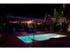 Outdoor pool with lounge area and pergola, enhanced with ambient lighting for evening enjoyment at 1835 Michigan Ne Ave, St Petersburg, FL 33703