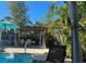 Inviting backyard pool area with pergola, dining table, and lush tropical landscaping at 1835 Michigan Ne Ave, St Petersburg, FL 33703