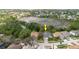 Aerial view of home showing surrounding homes, pond, and lush landscape at 1852 Longview Ln, Tarpon Springs, FL 34689