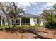 Back exterior of home showcasing a screened patio and traditional architecture at 1852 Longview Ln, Tarpon Springs, FL 34689