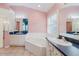Bathroom with double sinks, a corner bathtub, and a separate shower enclosure at 1852 Longview Ln, Tarpon Springs, FL 34689