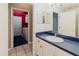 Bathroom with a vanity and view into the laundry area, featuring a washing machine at 1852 Longview Ln, Tarpon Springs, FL 34689