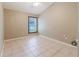 Neutral bedroom with a ceiling fan and tile flooring at 1852 Longview Ln, Tarpon Springs, FL 34689