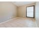 Neutral bedroom with a window and tile flooring at 1852 Longview Ln, Tarpon Springs, FL 34689