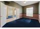 Bedroom with navy carpet, and a large window letting in natural light at 1852 Longview Ln, Tarpon Springs, FL 34689