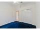 Bright bedroom with a closet and blue carpeting at 1852 Longview Ln, Tarpon Springs, FL 34689