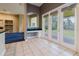 Bright breakfast nook with black and white decor, a built-in desk, and access to the patio at 1852 Longview Ln, Tarpon Springs, FL 34689