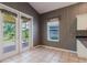 Bright breakfast nook with black and white wallpaper and access to the backyard at 1852 Longview Ln, Tarpon Springs, FL 34689