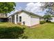 Exterior rear of home with stucco and landscaping at 1852 Longview Ln, Tarpon Springs, FL 34689