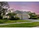 Beautiful single-story home with well-maintained landscaping, a two-car garage, and a welcoming facade at 1852 Longview Ln, Tarpon Springs, FL 34689