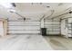 Garage with white doors and an automatic door opener at 1852 Longview Ln, Tarpon Springs, FL 34689