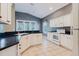 Inviting kitchen with white cabinets and black countertops at 1852 Longview Ln, Tarpon Springs, FL 34689