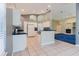 Open kitchen layout connects to living area with white cabinetry and black countertops at 1852 Longview Ln, Tarpon Springs, FL 34689