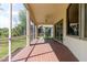 Relaxing screened-in patio with brick flooring, ceiling fan, and views of the surrounding greenery at 1852 Longview Ln, Tarpon Springs, FL 34689