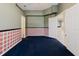 A cozy room with wainscoting, adjacent rooms, and multiple entryways, offers versatility and charm at 1852 Longview Ln, Tarpon Springs, FL 34689
