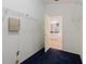 Spacious walk-in closet with shelving and blue carpeting, leading to the bathroom at 1852 Longview Ln, Tarpon Springs, FL 34689