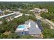 An aerial view of a building featuring a refreshing blue swimming pool and ample parking spaces at 2003 Greenbriar Blvd # 1, Clearwater, FL 33763