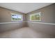A well lit room with two windows that offer a view of the greenery outside at 2003 Greenbriar Blvd # 1, Clearwater, FL 33763