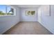 Bedroom featuring two windows offering natural light and tile floors at 2003 Greenbriar Blvd # 1, Clearwater, FL 33763