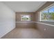 Cozy bedroom featuring neutral tones, tiled floors, and dual windows for natural light at 2003 Greenbriar Blvd # 1, Clearwater, FL 33763